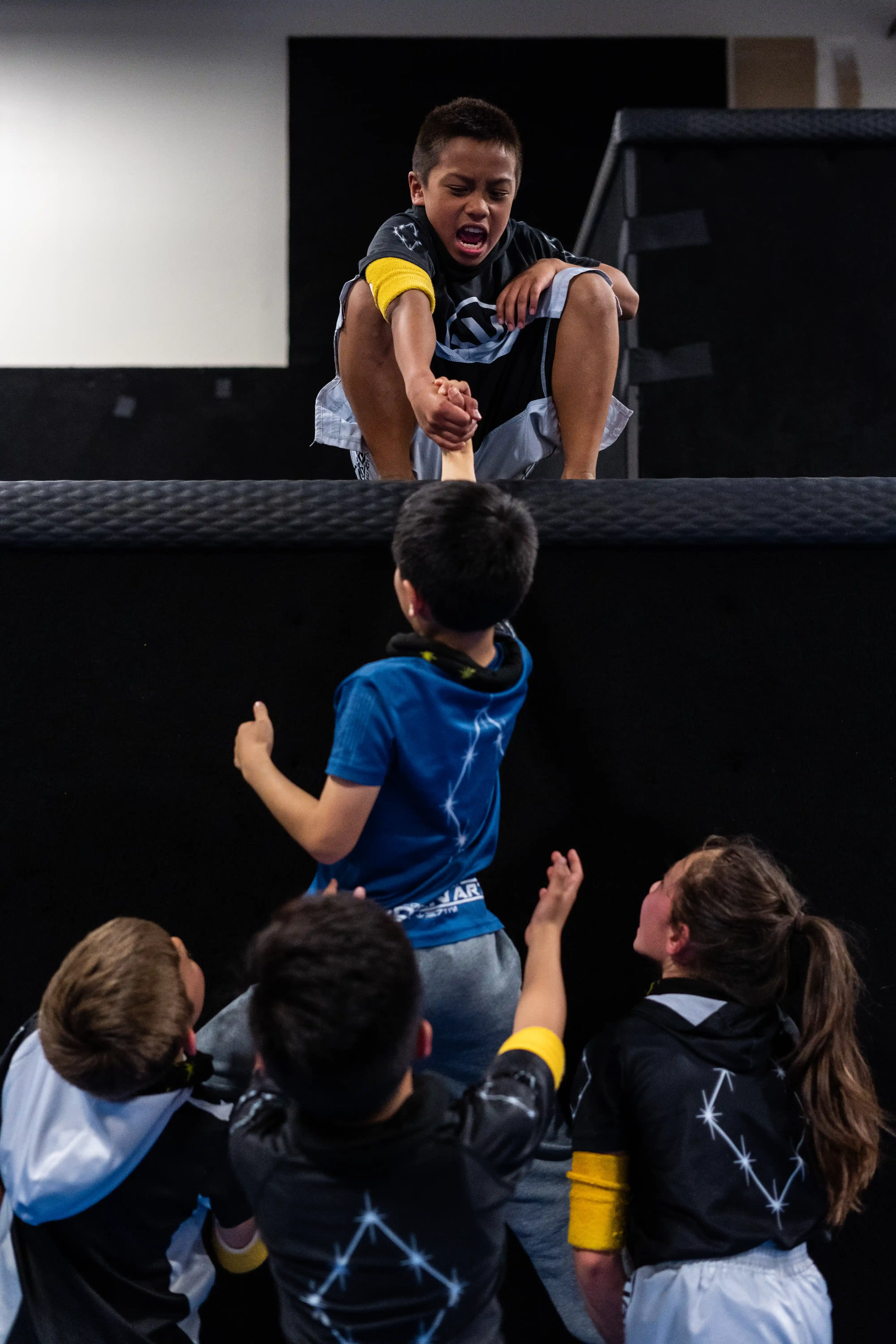 Kids training teamwork at a parkour gym in San Jose