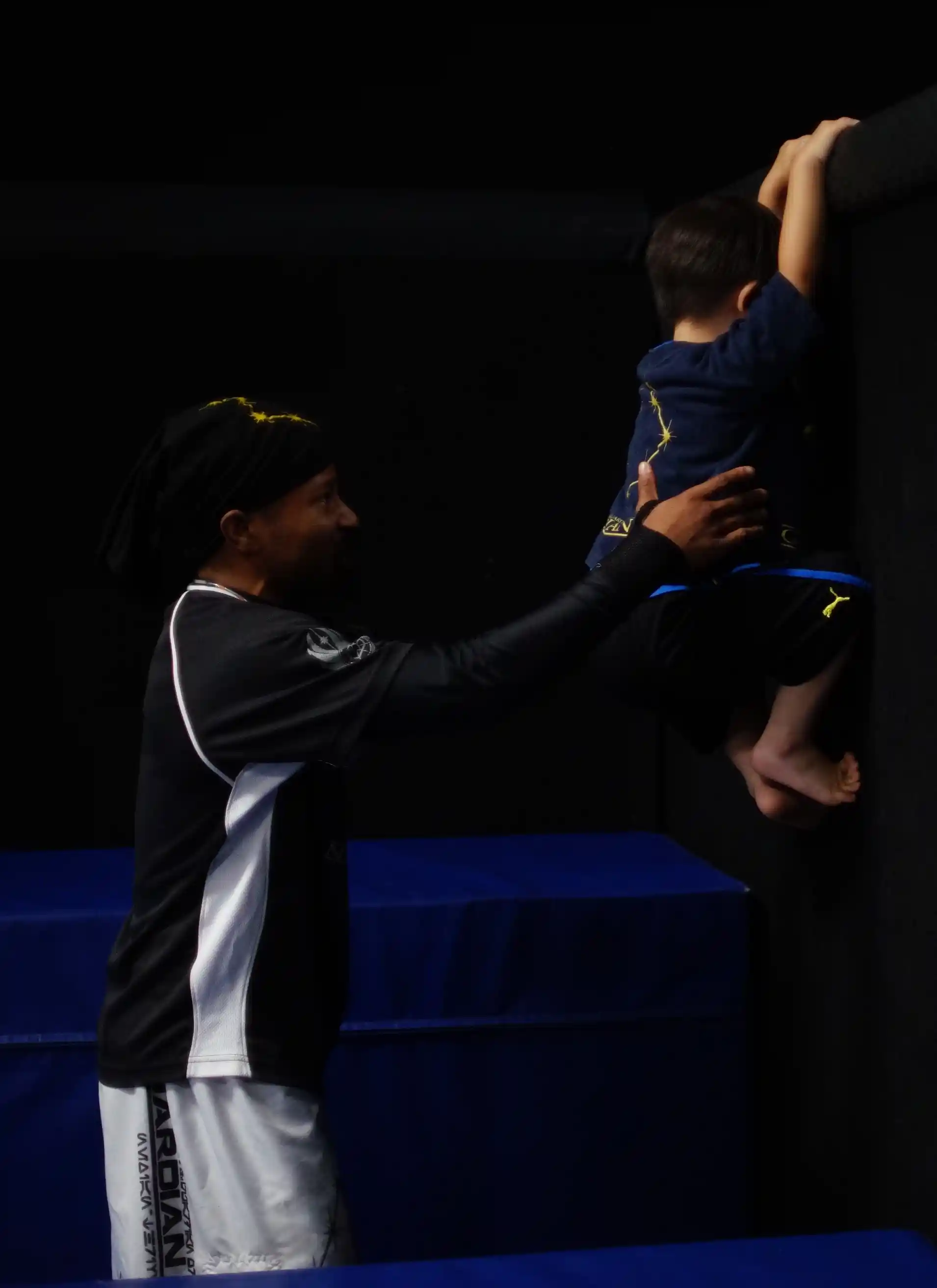 Experienced MMA and Parkour instructors teaching toddler in San Jose